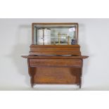 A brass barograph in a glazed oak case with wall bracket fitted with a drawer, glass cracked, drawer