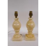 A pair of carved alabaster lamps, with shades, 28cm high