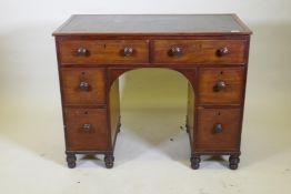 A George III mahogany six drawer kneehole desk with a leather inset top and turned feet, 102 x 51cm,