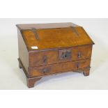 An early C18th walnut bible box with fall front and single drawer, raised on bracket supports,