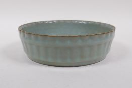 A Chinese celadon crackle glazed porcelain bowl of ribbed form, 18cm diameter