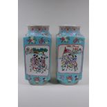 A pair of blue ground square form porcelain vases with famille rose decorative panels depicting