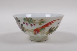 An early C20th famille vert porcelain tea bowl decorated with birds amongst flowers, Chinese GuangXu