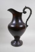 A patinated hammered copper urn with bronze handle, 39cm high