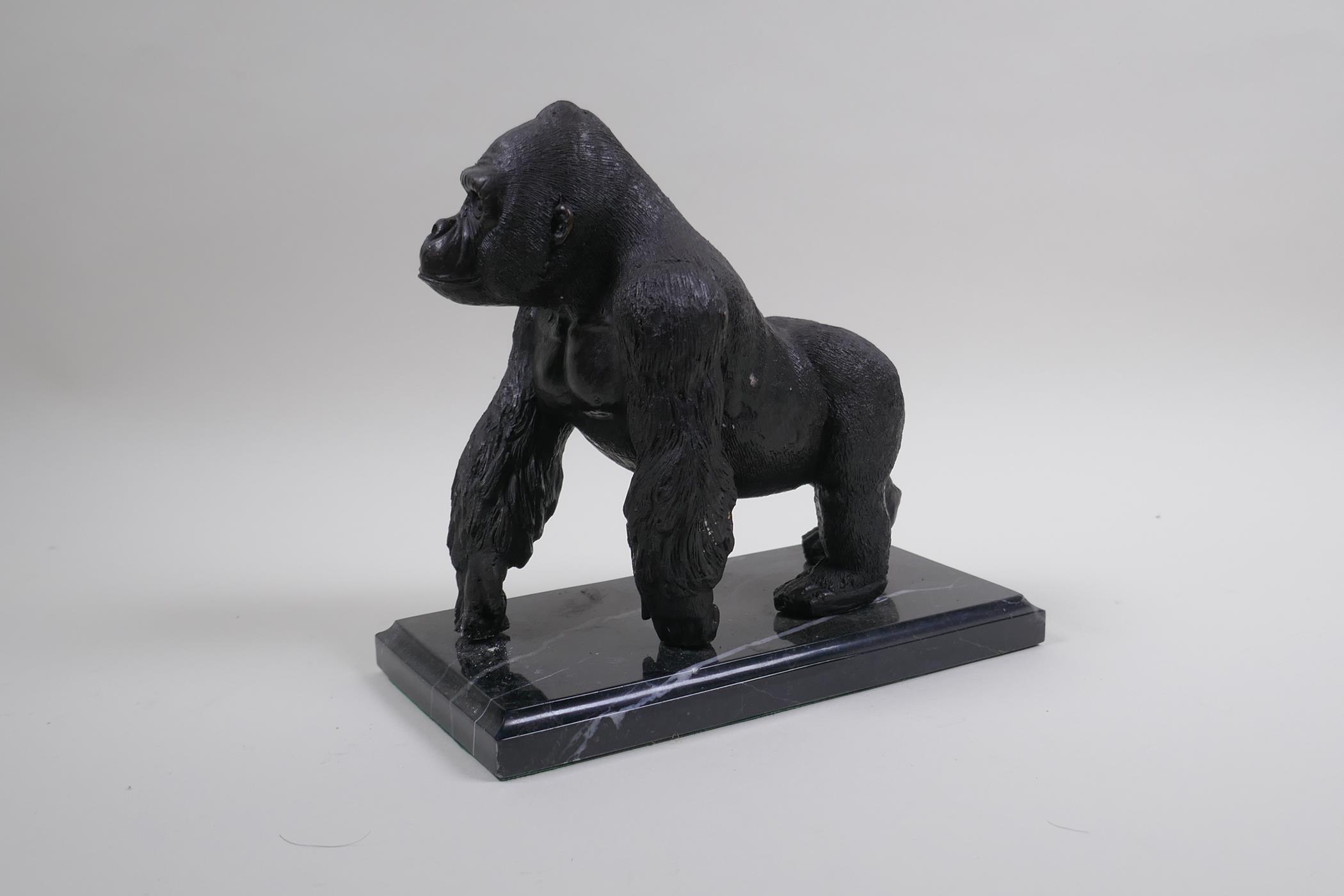 A cast bronze figure of a prowling gorilla, 18cm high