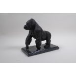 A cast bronze figure of a prowling gorilla, 18cm high