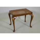 A Georgian style walnut stool with carved and parcel gilt decoration and cane seat, 56 x 41cm,