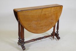 A Victorian walnut Sutherland table with turned supports and centre stretcher, 104 x 89 x 70cm