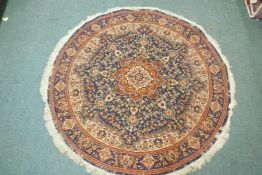 A wool carpet with Persian style designs on a red field with blue borders, 180cm diameter
