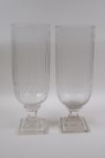 A pair of glass hurricane vases with cut glass decoration, 34cm high, 12cm high