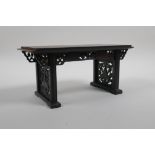 A Chinese carved and pierced hardwood stand in the form of a miniature altar table, 22cm wide