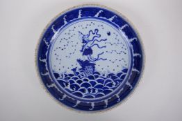 A Chinese blue and white porcelain charger decorated with an immortal riding a carp, 29cm diameter