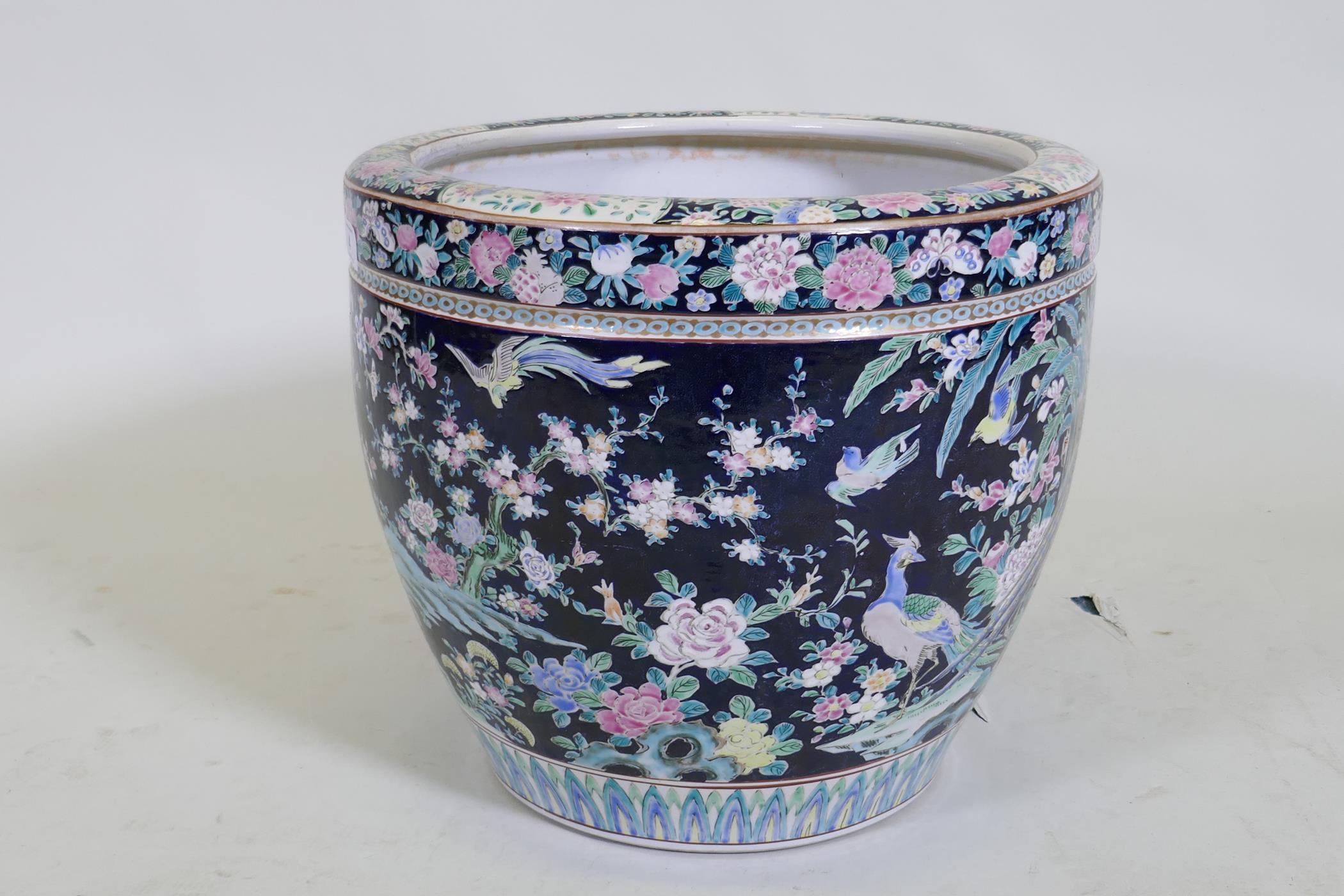 An antique Chinese famille noire ceramic jardiniere, decorated with exotic birds and flowers, 33cm - Image 2 of 7