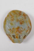 A Chinese nephrite jade belt buckle with carved dragon mask decoration, 8 x 9cm