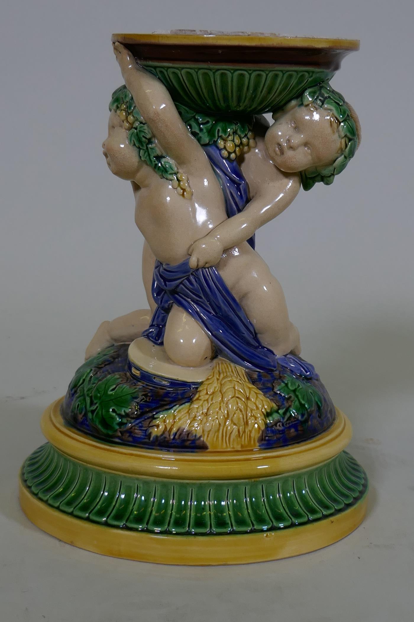 A Victorian majolica centre piece stand in the form of two putti, in the style of Minton, 23cm high, - Image 2 of 9