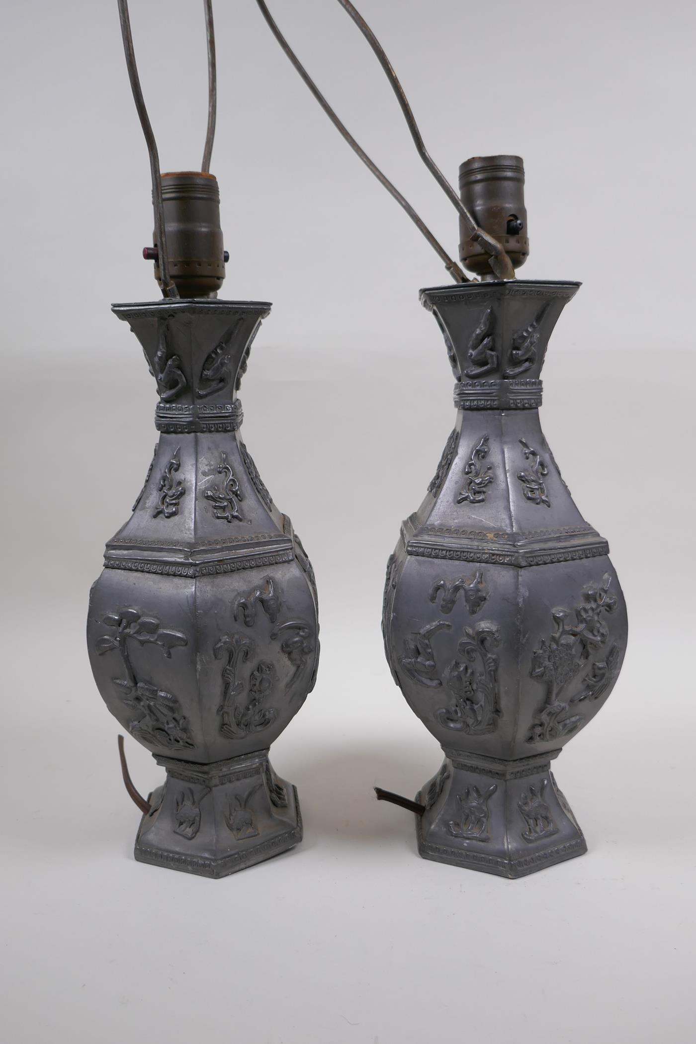 A pair of Chinese pewter lamps decorated with mythical creatures and auspicious symbols, 35cm high - Image 4 of 4