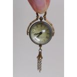 A brass and glass miniature ball clock pendant, 8cm drop