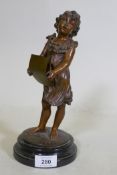 A C19th bronzed spelter figure of a young girl singing from a song sheet, mounted on a marble