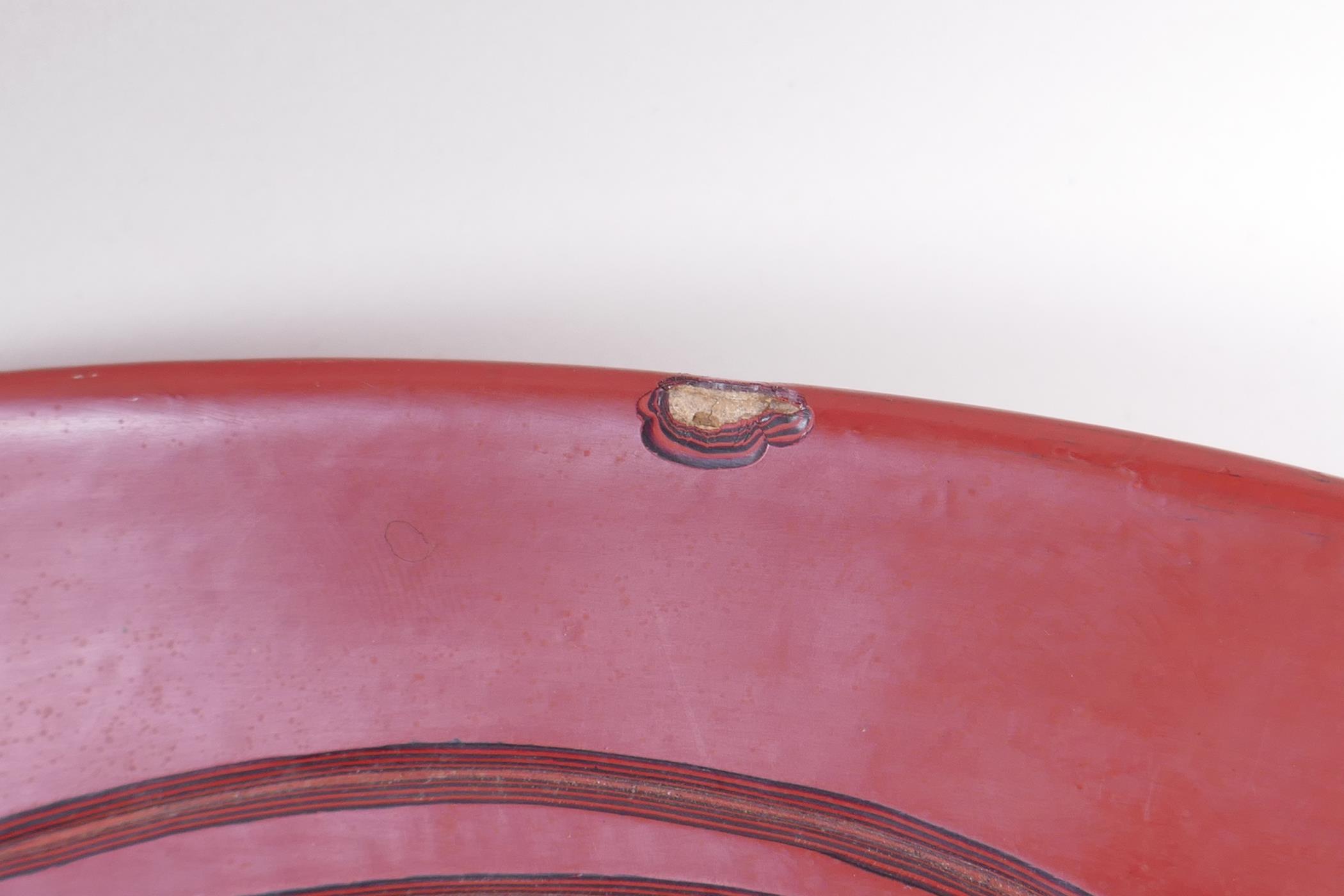 A Chinese red Tixi lacquer charger with stylised bird decoration, Xuande 4 character mark to base, - Image 5 of 8