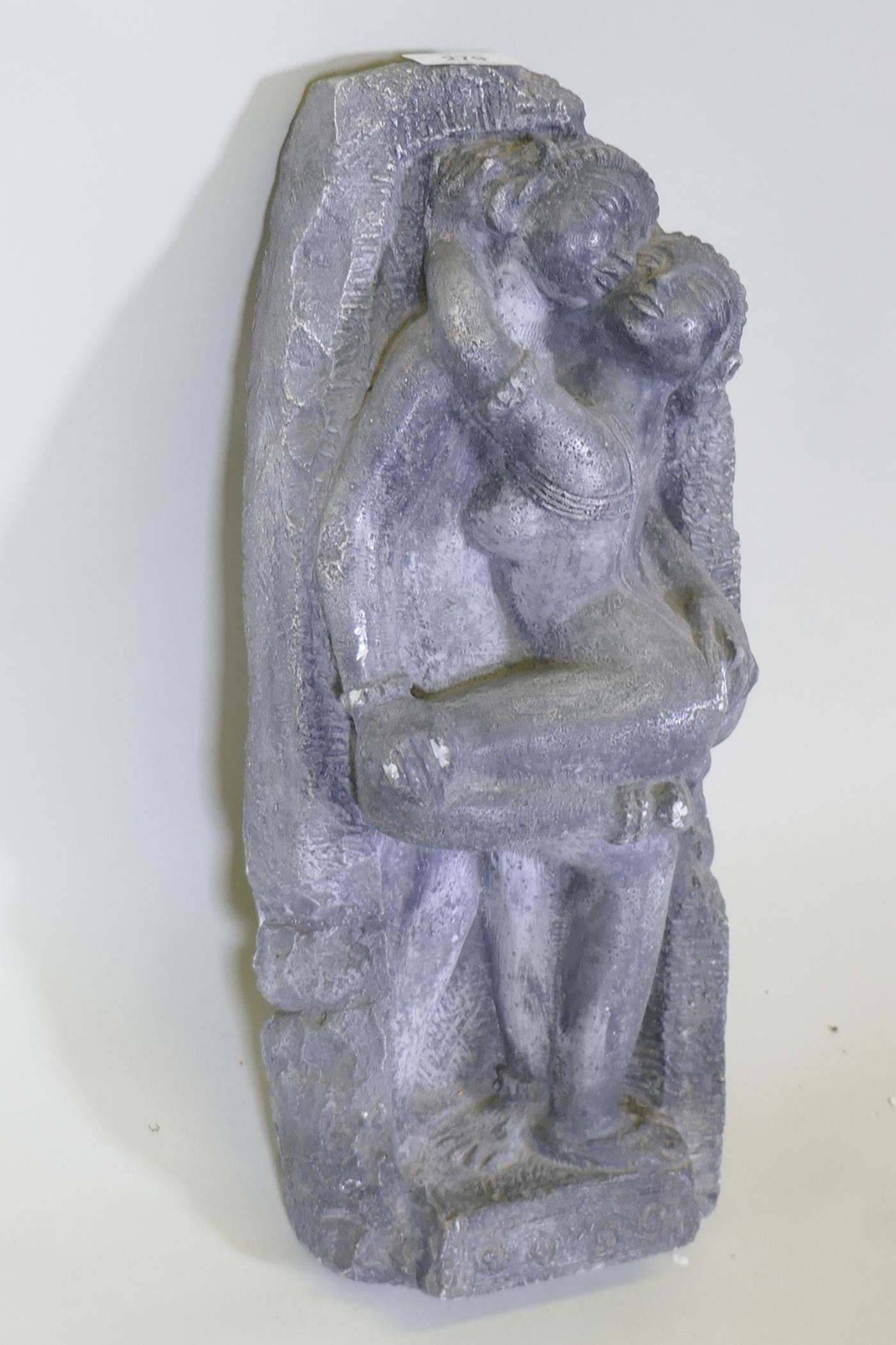 A painted plaster cast after an antique Indian carving of an embracing couple, 44cm long - Image 2 of 2