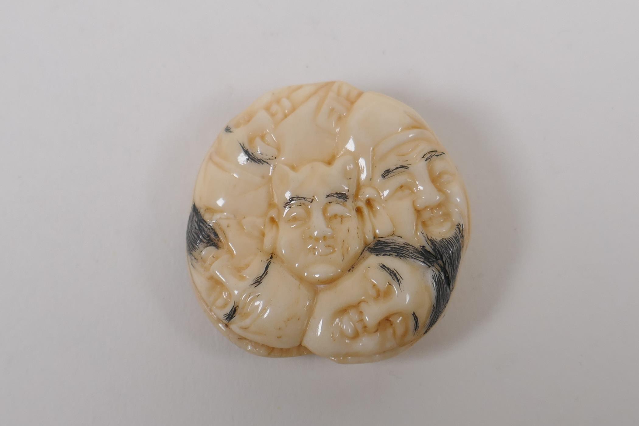 A Japanese bone netsuke with carved mask decoration, signed, 4cm diameter - Image 2 of 4