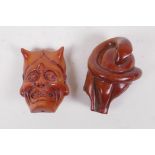 A Japanese carved boxwood netsuke in the form of an oni mask, and another carved in the form of a