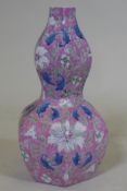 A Chinese double gourd shaped porcelain table lamp with lotus flower decoration and pink glaze,