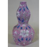 A Chinese double gourd shaped porcelain table lamp with lotus flower decoration and pink glaze,