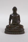 A bronze figure of Buddha seated in mediation, 9cm high