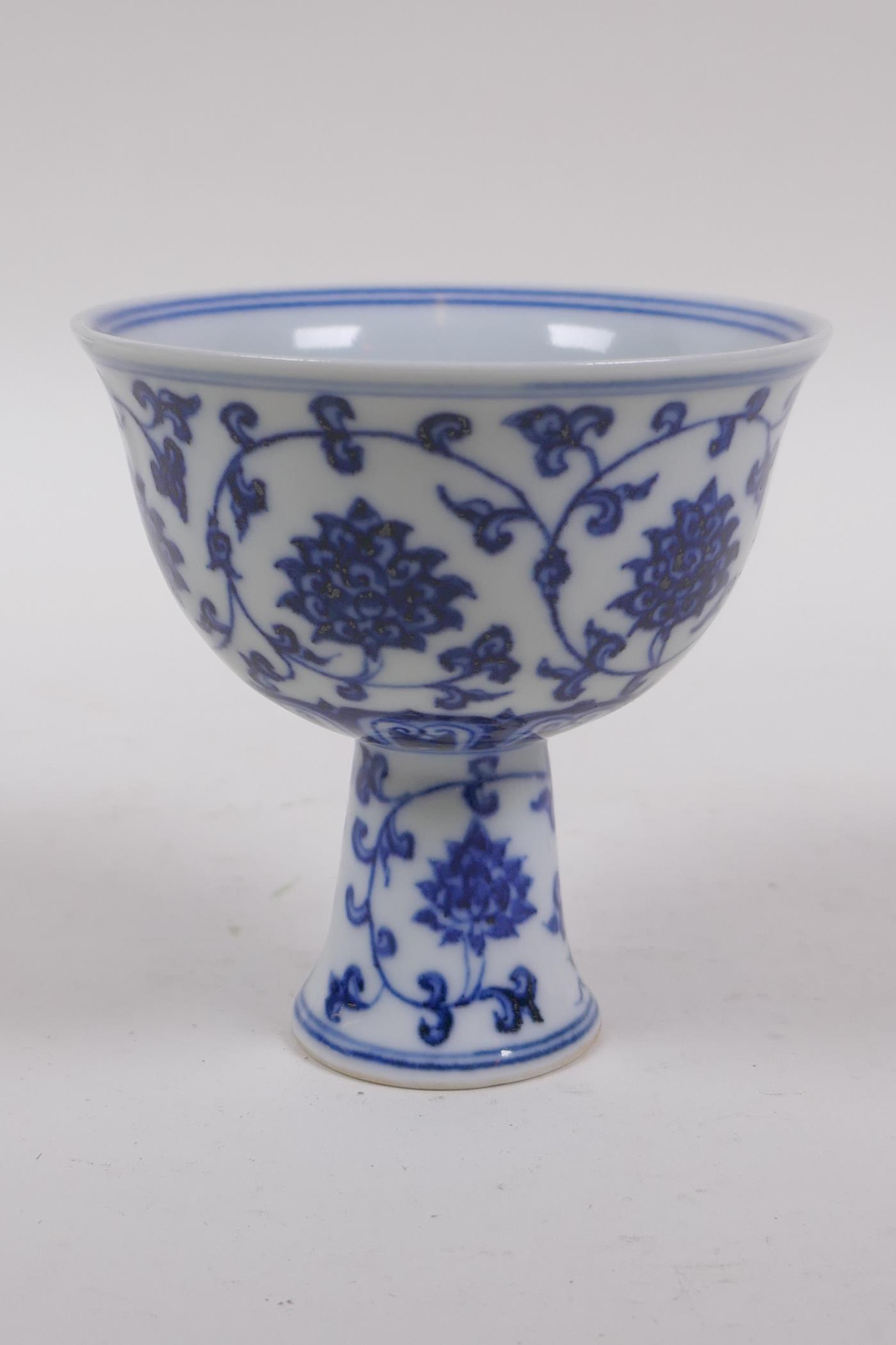 A blue and white porcelain stem bowl with scrolling lotus flower decoration, Chinese Xuande 6 - Image 2 of 5