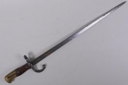 A late C19th French model 1880 bayonet, manufactured in St Etienne, inscription to the blade, the