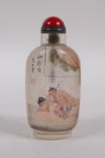 A Chinese reverse decorated glass snuff bottle depicting an erotic scene, inscription verso, 10cm