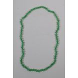 A green hardstone bead necklace, 68cm long
