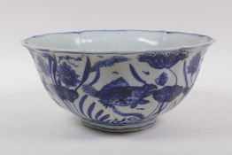 A blue and white porcelain bowl of lobed form, decorated with carp in a lotus pond, Chinese Xuande 6
