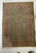 A fine woven green ground Turkish rug with an allover Bokharra style design, 130 x 182cm