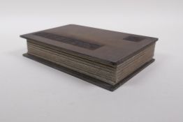 A Chinese wood and silk bound book containing black hardstone tablets with chased and gilt character