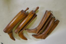 Two pairs of antique boot jacks, largest 60 cm long including handle
