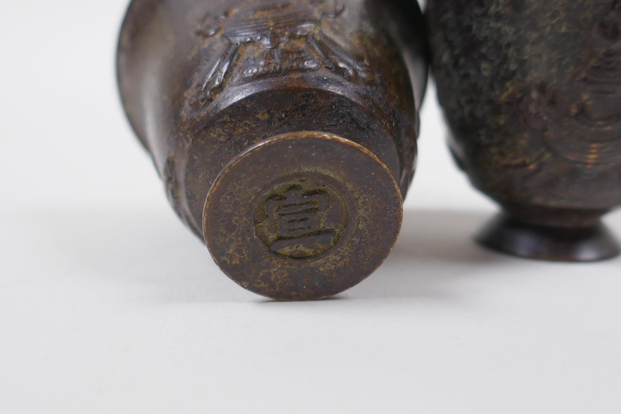 A pair of Chinese bronze tea bowls, character marks to base, 4cm high, 5cm diameter - Image 2 of 2