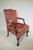 A late C19th Gainsborough chair with hump back, scroll arms, carved cabriole legs and ball and