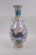 A Chinese polychrome porcelain vase with two mask handles decorated with lotus flowers and