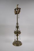 A middle eastern brass four branch whale lamp converted to electricity, 55cm high