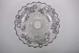 A silver overlaid glass fruit bowl decorated with a rose design, 32cm diameter