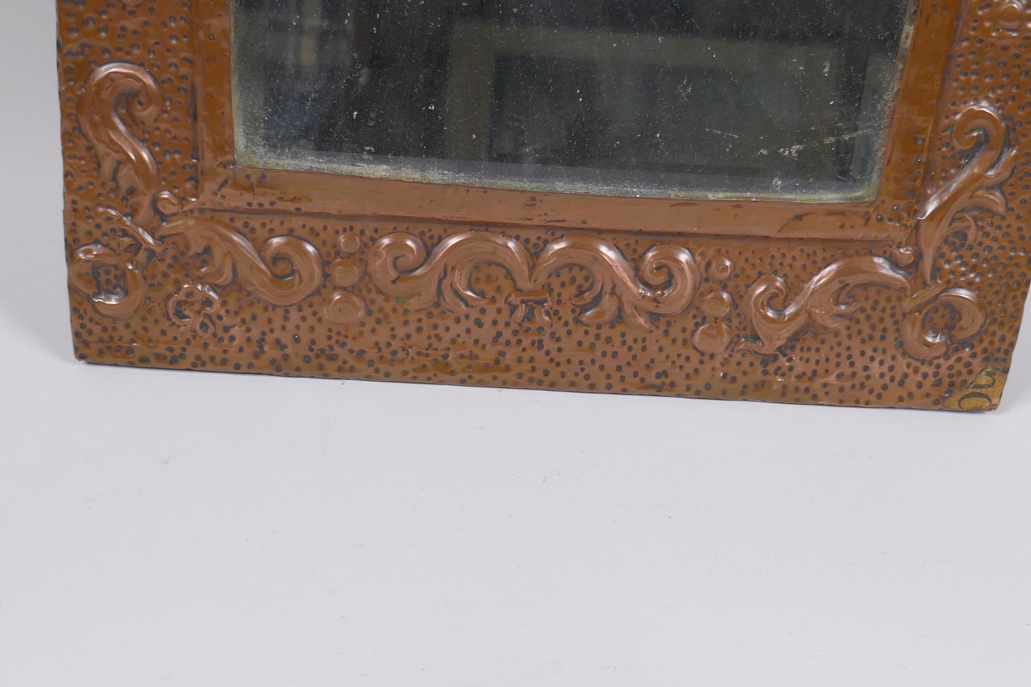 An antique beaten copper wall mirror with repousse swag decoration, 56 x 28cm - Image 2 of 3