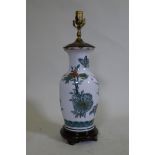 A porcelain table lamp with butterfly and lotus flower decoration in the Chinese manner, 57cm high