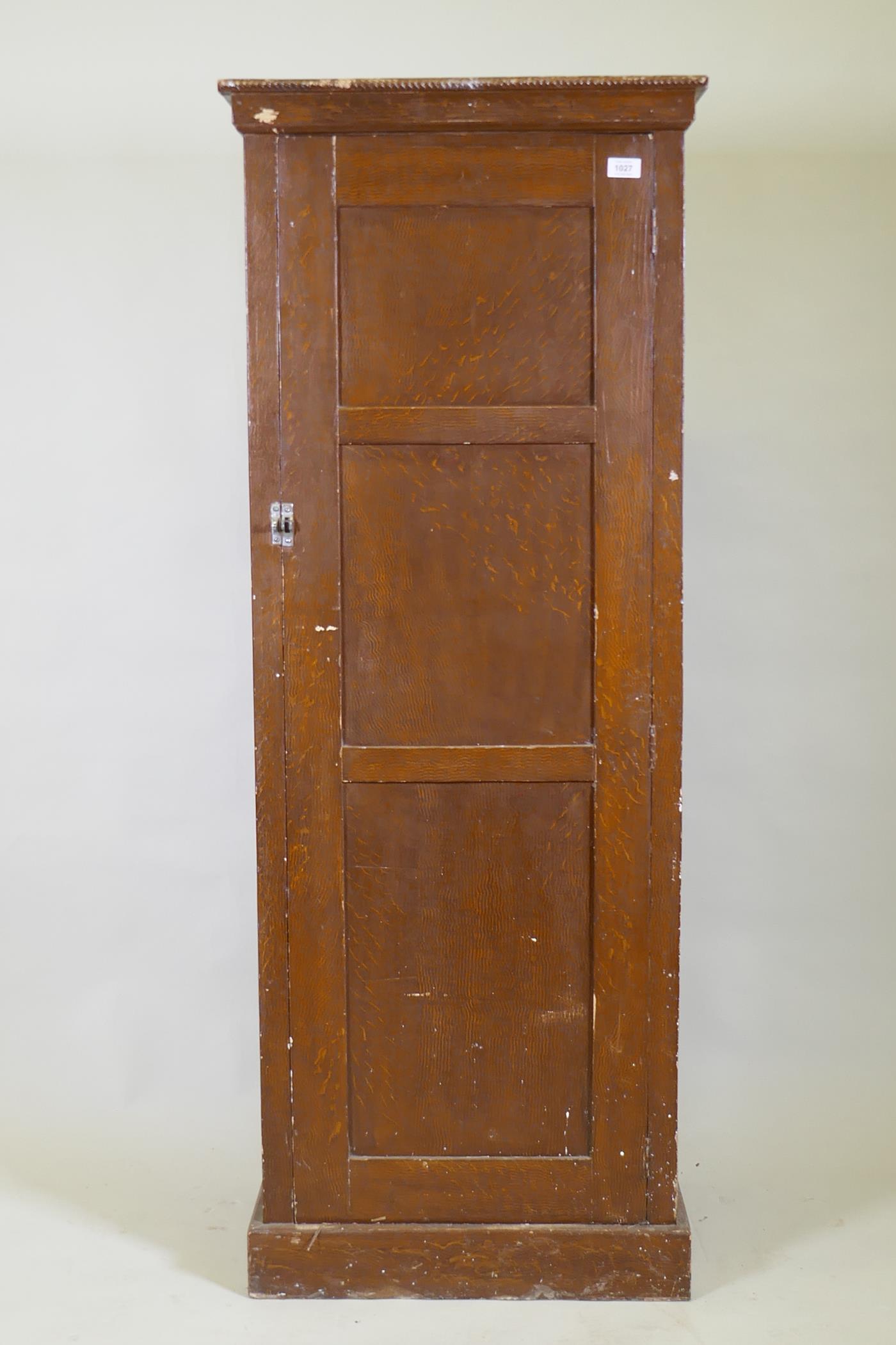 A late C19th/early C20th grain painted cupboard with panelled sides and door, rope twist carved