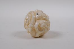 A Japanese bone ball weight with carved mermaid decoration 3cm diameter