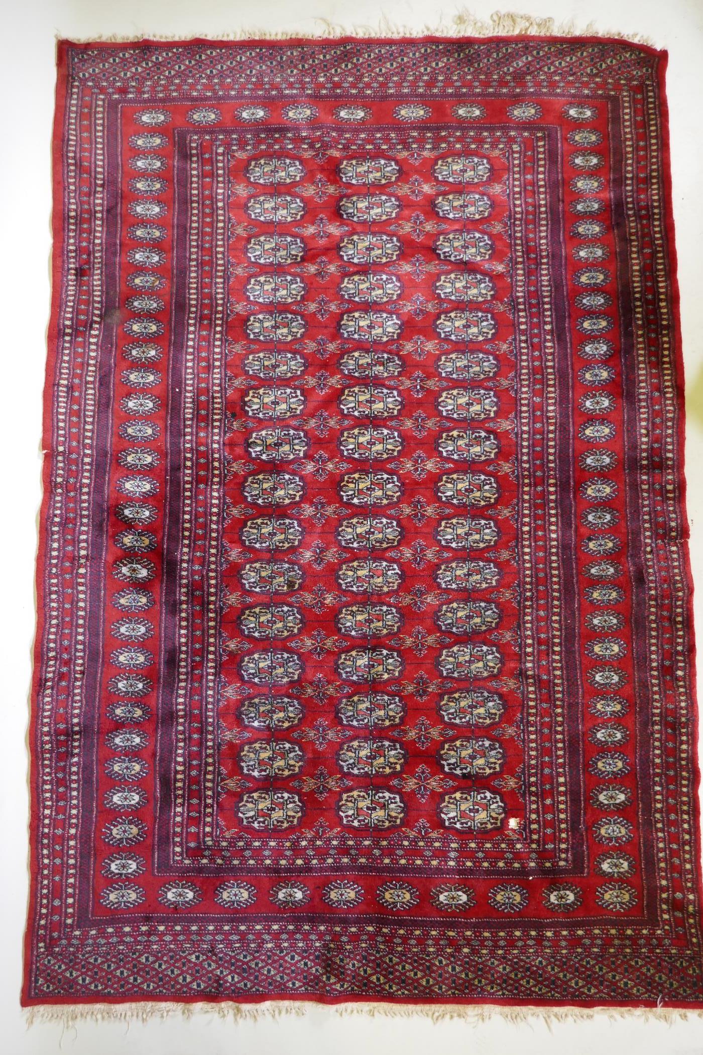A fine woven red ground wool Bokharra rug, AF, 128 x 190cm - Image 2 of 7