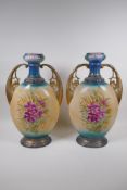 A pair of Edwardian porcelain vases with gilt handles and floral decoration, 44cm high, AF