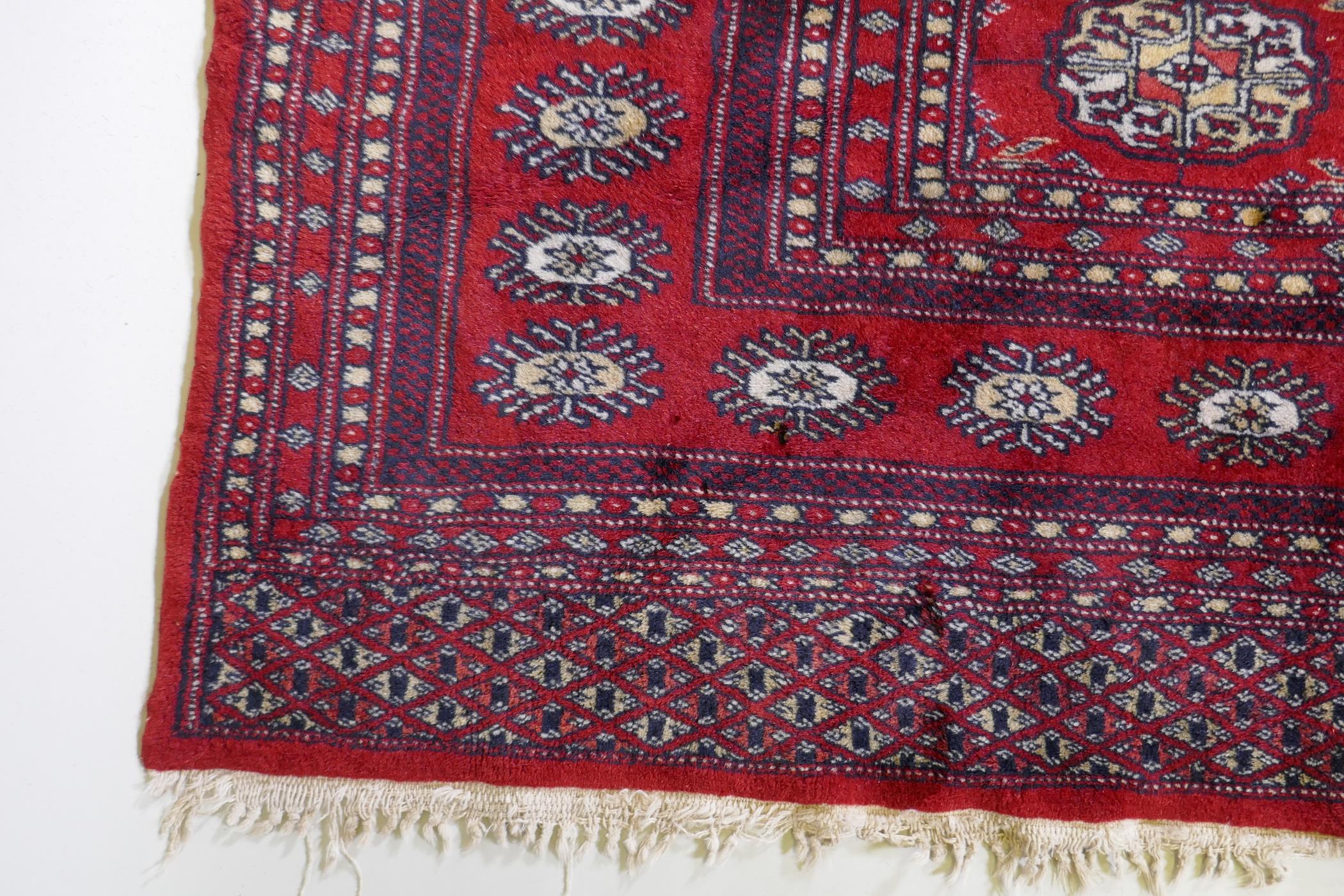A fine woven red ground wool Bokharra rug, AF, 128 x 190cm - Image 3 of 7