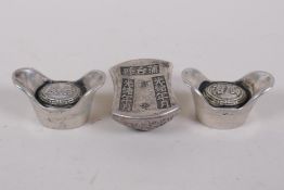 A pair of Chinese white metal tokens/ingots and another similar with impressed character marks,
